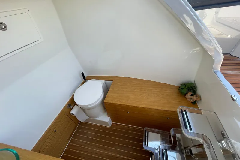 Slide: The Image of Modern boat bathroom with wooden accents, featuring a toilet and storage, Skipper-BSK BSK 38, 2023. - 26