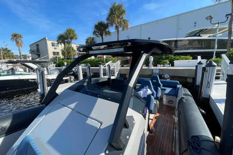 Slide: The Image of 2023 Skipper-BSK BSK 38 boat docked at marina with palm trees and clear sky. - 29