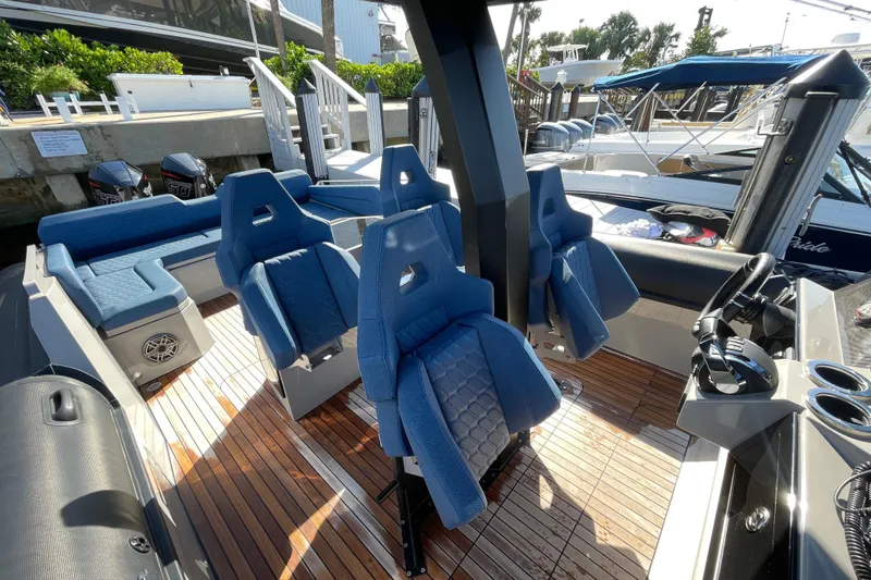 Slide: The Image of 2023 Skipper-BSK BSK 38 boat interior with blue seats and wooden deck. - 33