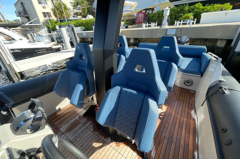 Slide: The Image of 2023 Skipper-BSK BSK 38 boat interior with blue seats and wooden deck. - 34
