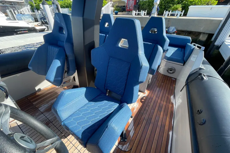 Slide: The Image of 2023 Skipper-BSK BSK 38 boat interior with blue seats and wooden deck. - 35