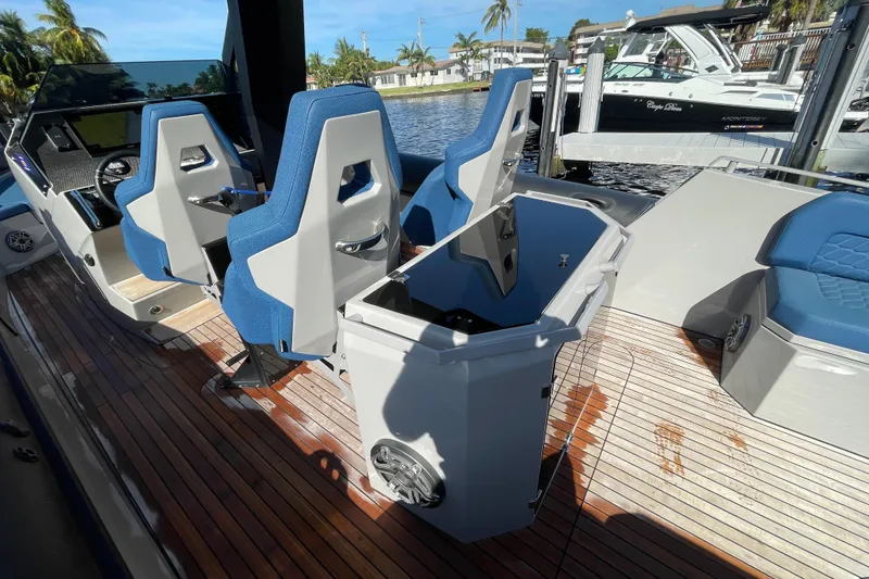 Slide: The Image of 2023 Skipper-BSK BSK 38 boat interior with blue seats and wooden deck. - 37