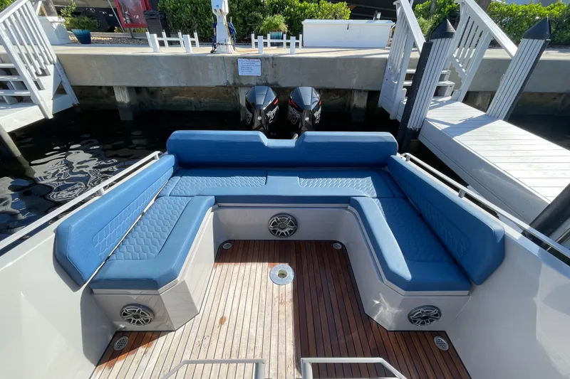 Slide: The Image of Luxurious seating area on 2023 Skipper-BSK BSK 38 boat with blue cushions and wooden deck. - 43
