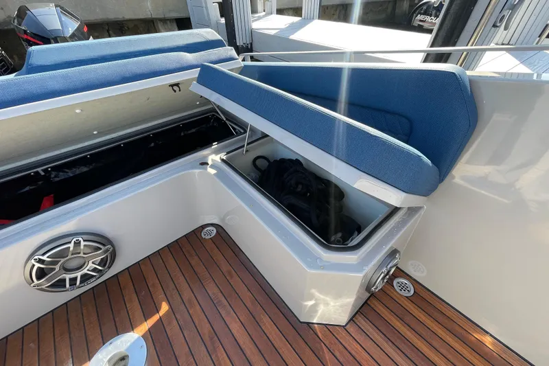Slide: The Image of 2023 Skipper-BSK BSK 38 boat interior with open storage compartment and blue seating. - 48