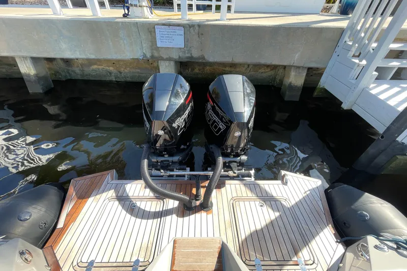 Slide: The Image of Twin outboard motors on a 2023 Skipper-BSK BSK 38 boat at a dock. - 49