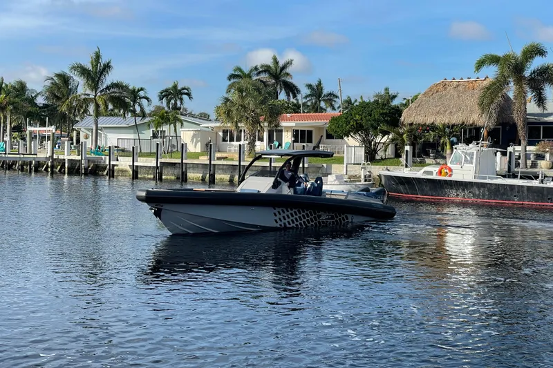 Slide: The Image of 2023 Skipper-BSK BSK 38 boat cruising near waterfront homes with palm trees. - 7
