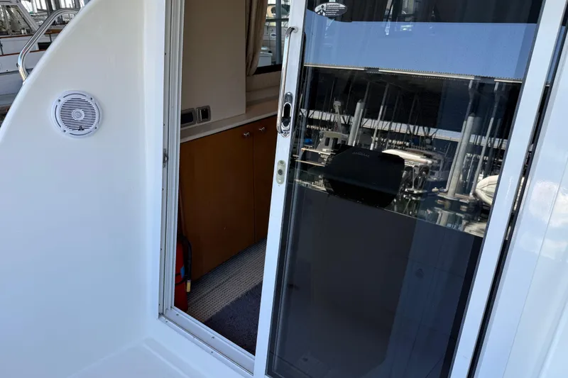 Slide: The Image of 2005 Meridian 341 Sedan yacht interior with sliding glass door and wooden cabinetry. - 1