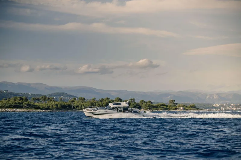 Slide: The Image of Nimbus Tender 11 2025 cruising on open sea near coastal landscape. - 6