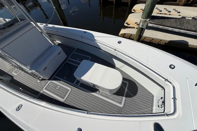 Slide: The Image of 2015 Contender 32 ST boat deck with seating and storage, docked at marina. - 10