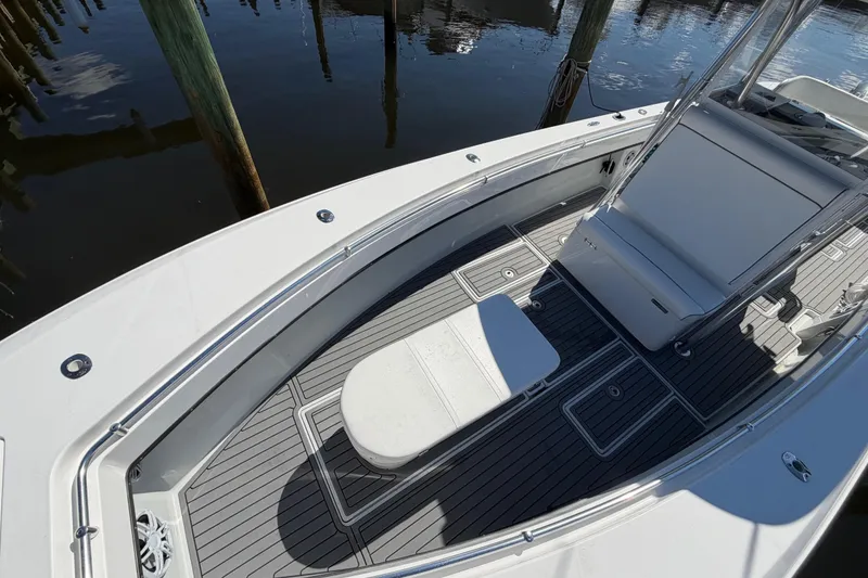 Slide: The Image of 2015 Contender 32 ST boat deck with seating, docked by wooden posts. - 11