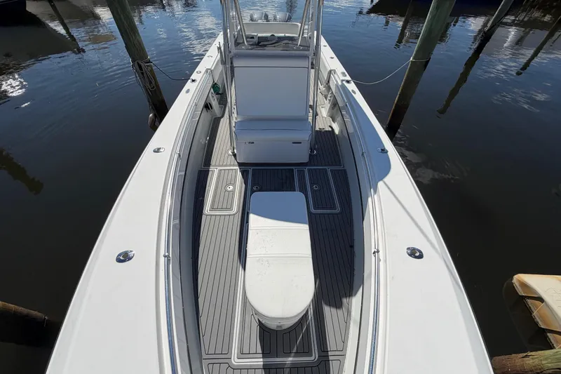 Slide: The Image of 2015 Contender 32 ST boat docked, showcasing spacious deck and seating area. - 12