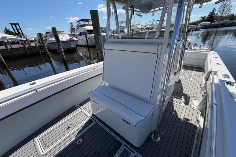 Slide: The Image of 2015 Contender 32 ST boat interior with seating, docked at marina. - 14