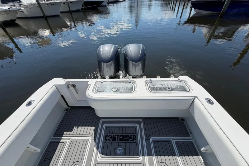 Slide: The Image of 2015 Contender 32 ST boat with dual engines docked at marina. - 17
