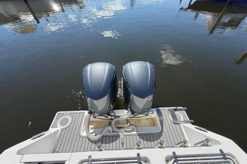 Slide: The Image of 2015 Contender 32 ST boat with dual outboard motors on calm water. - 18