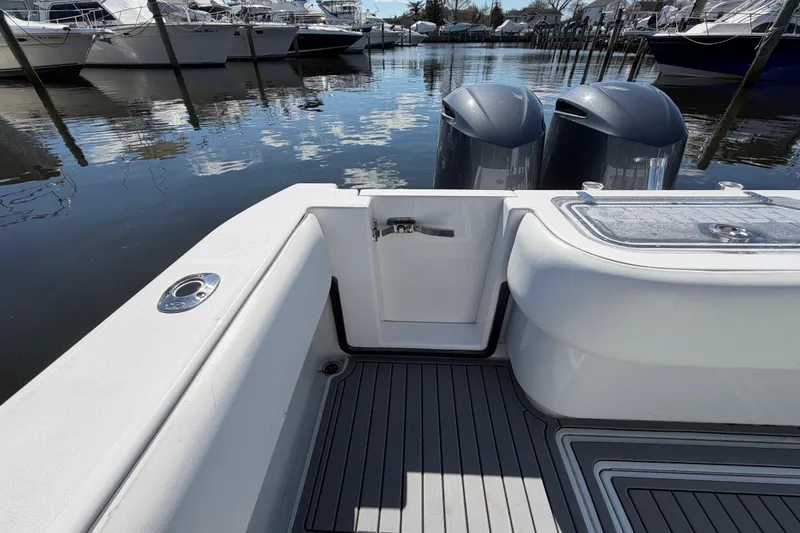 Slide: The Image of 2015 Contender 32 ST boat with dual engines docked in a marina. - 20