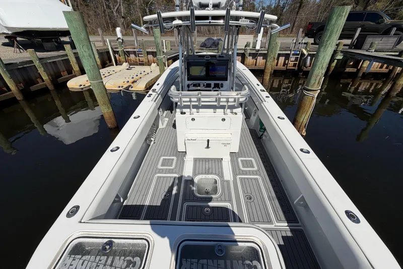 Slide: The Image of 2015 Contender 32 ST boat docked, showcasing spacious deck and modern console. - 23