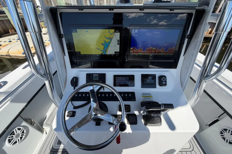 Slide: The Image of 2015 Contender 32 ST boat dashboard with navigation screens and steering wheel. - 24