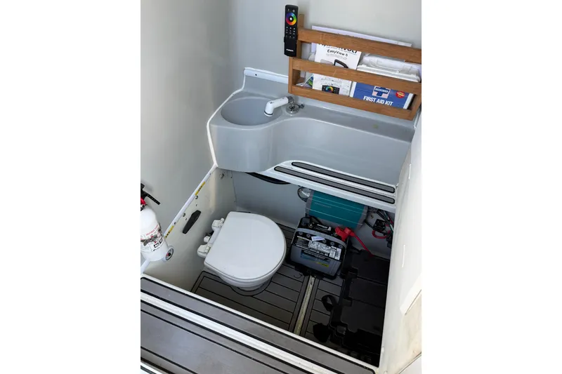 Slide: The Image of 2015 Contender 32 ST boat interior with sink, toilet, and storage area. - 25