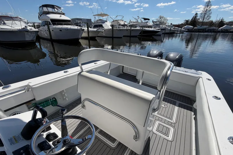 Slide: The Image of 2015 Contender 32 ST boat docked at marina with clear skies and calm waters. - 26