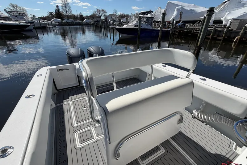 Slide: The Image of 2015 Contender 32 ST boat interior with dual engines, docked in a marina. - 27