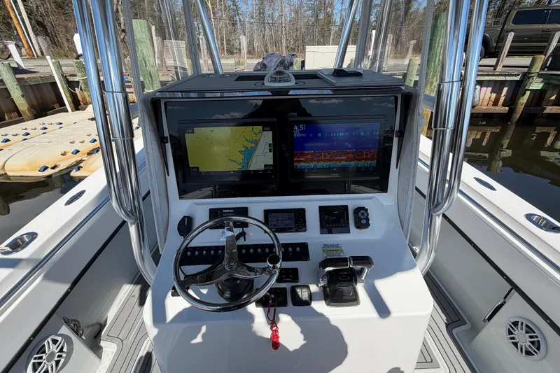Slide: The Image of 2015 Contender 32 ST boat dashboard with navigation screens and steering wheel. - 28