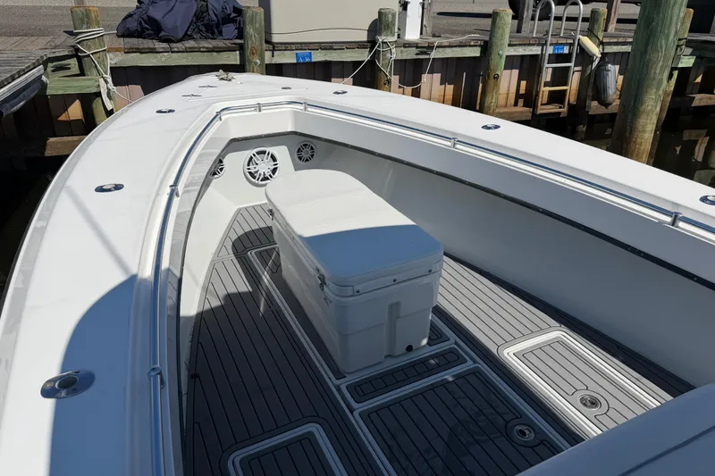 Slide: The Image of 2015 Contender 32 ST boat interior with seating and storage at dock. - 30