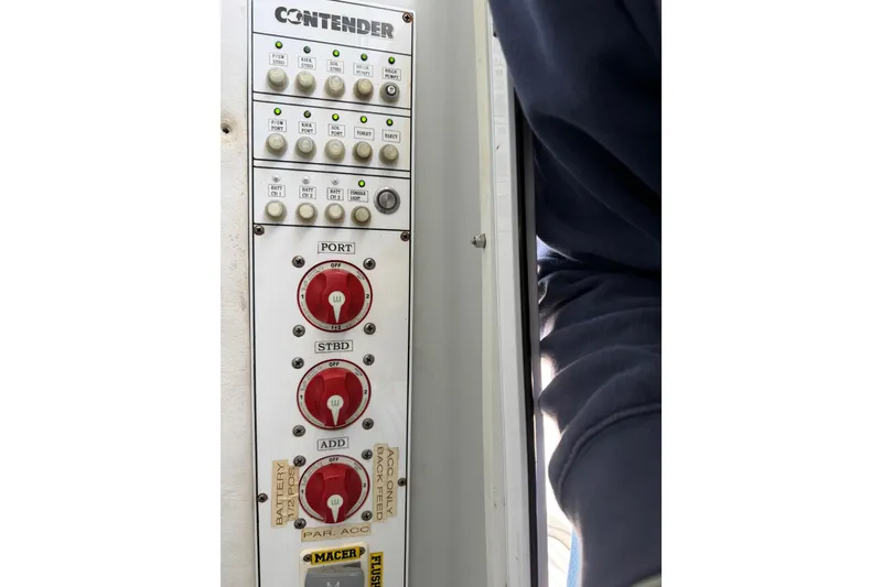 Slide: The Image of Control panel of a 2015 Contender 32 ST boat with switches and dials. - 31