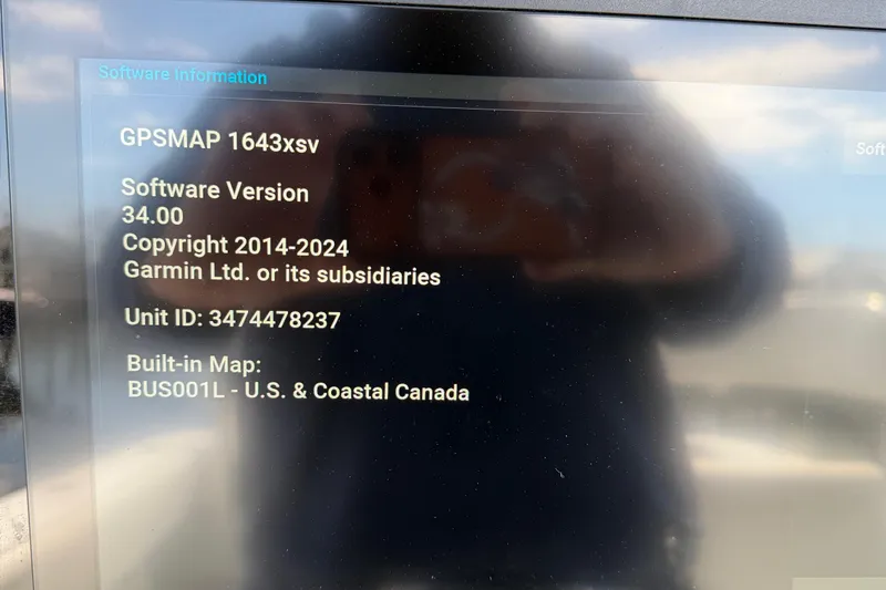Slide: The Image of Display showing Garmin GPSMAP 1643xsv software information on Contender 32 ST, 2015 model. - 34