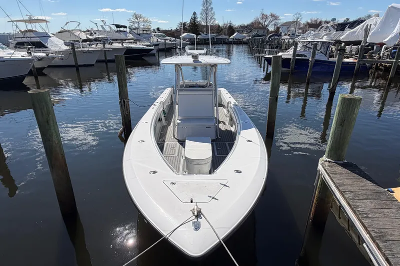 Slide: The Image of 2015 Contender 32 ST boat docked in a marina, surrounded by other vessels. - 7