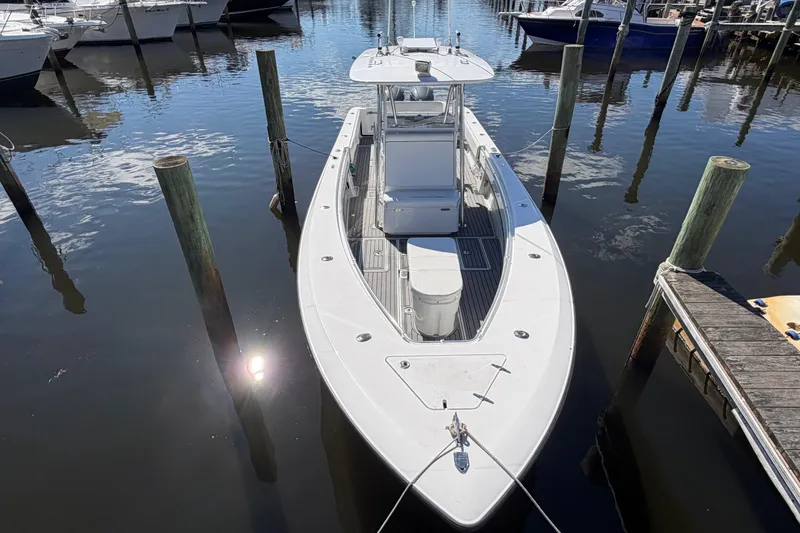 Slide: The Image of 2015 Contender 32 ST boat docked in a marina, viewed from above. - 8