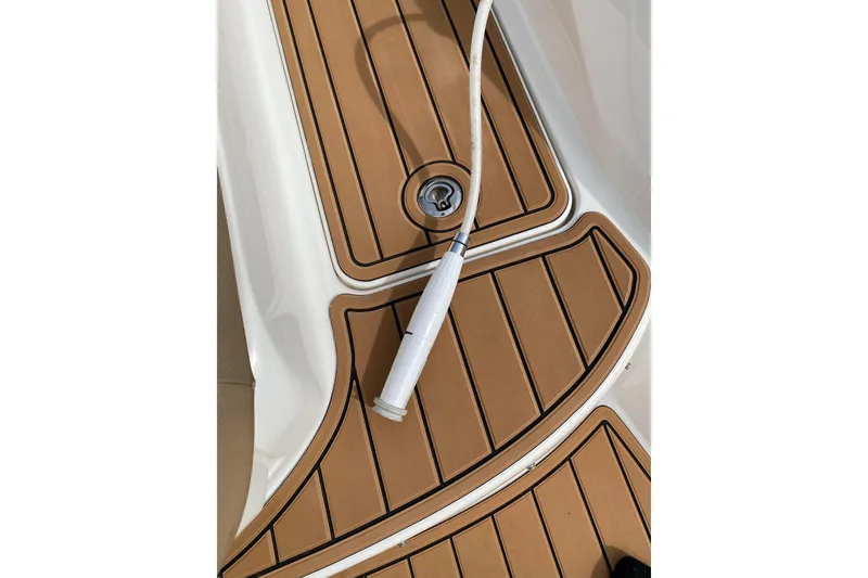 Slide: The Image of Teak-style deck of 2016 Sea Ray SLX 280 boat with white hose. - 5