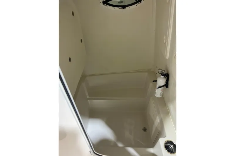 Slide: The Image of Interior of 2022 Sailfish 242 CC boat, featuring a compact storage area. - 14