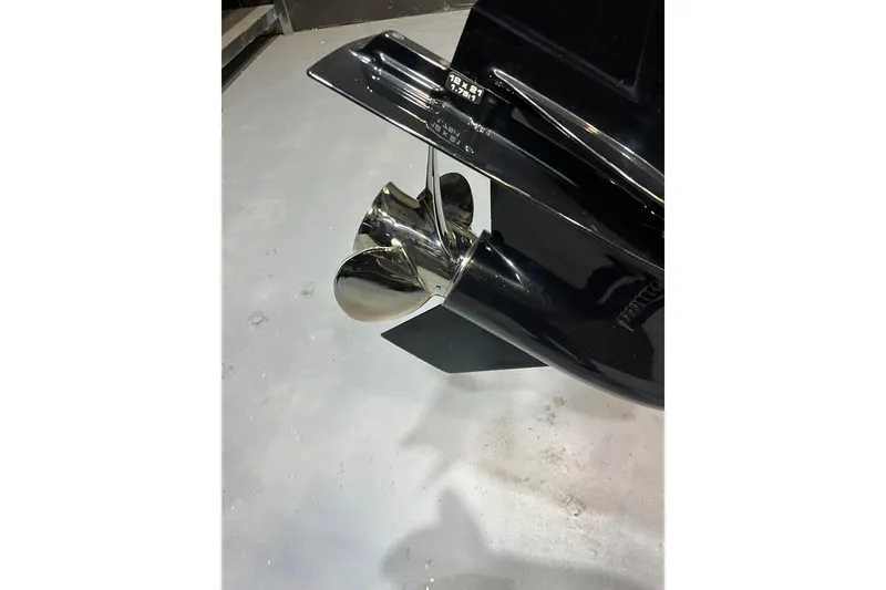 Slide: The Image of 2022 Sailfish 242 CC boat propeller, shiny chrome finish on a concrete floor. - 5