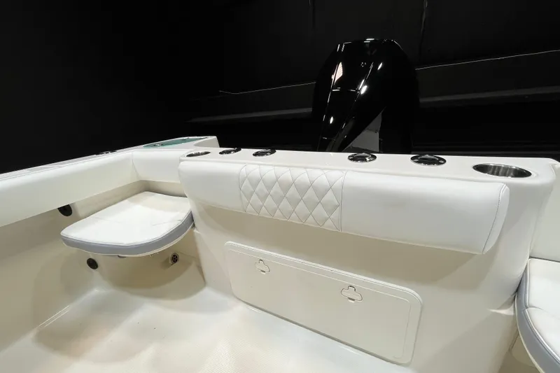 Slide: The Image of 2022 Sailfish 242 CC boat interior with white seating and storage compartments. - 7