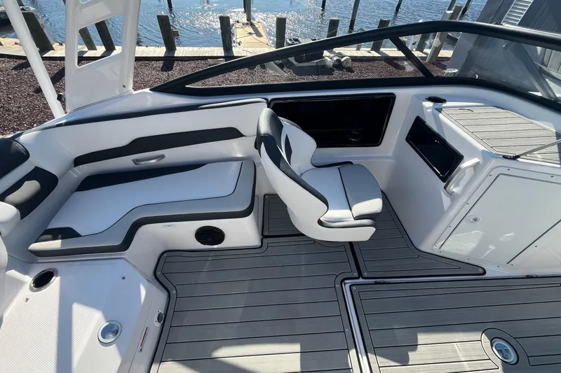Slide: The Image of 2025 Yamaha Boats 195S interior with sleek seating and modern design by the water. - 5