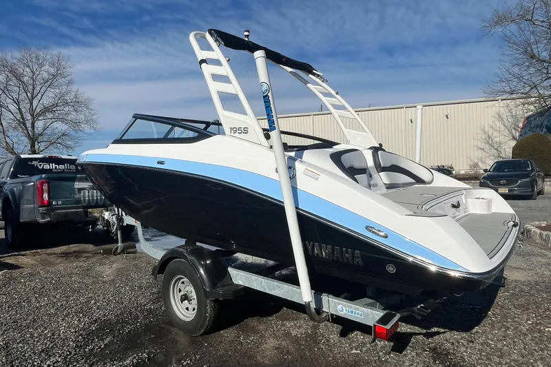 Slide: The Image of 2025 Yamaha Boats 195S on trailer, sleek design, parked outdoors. - 7