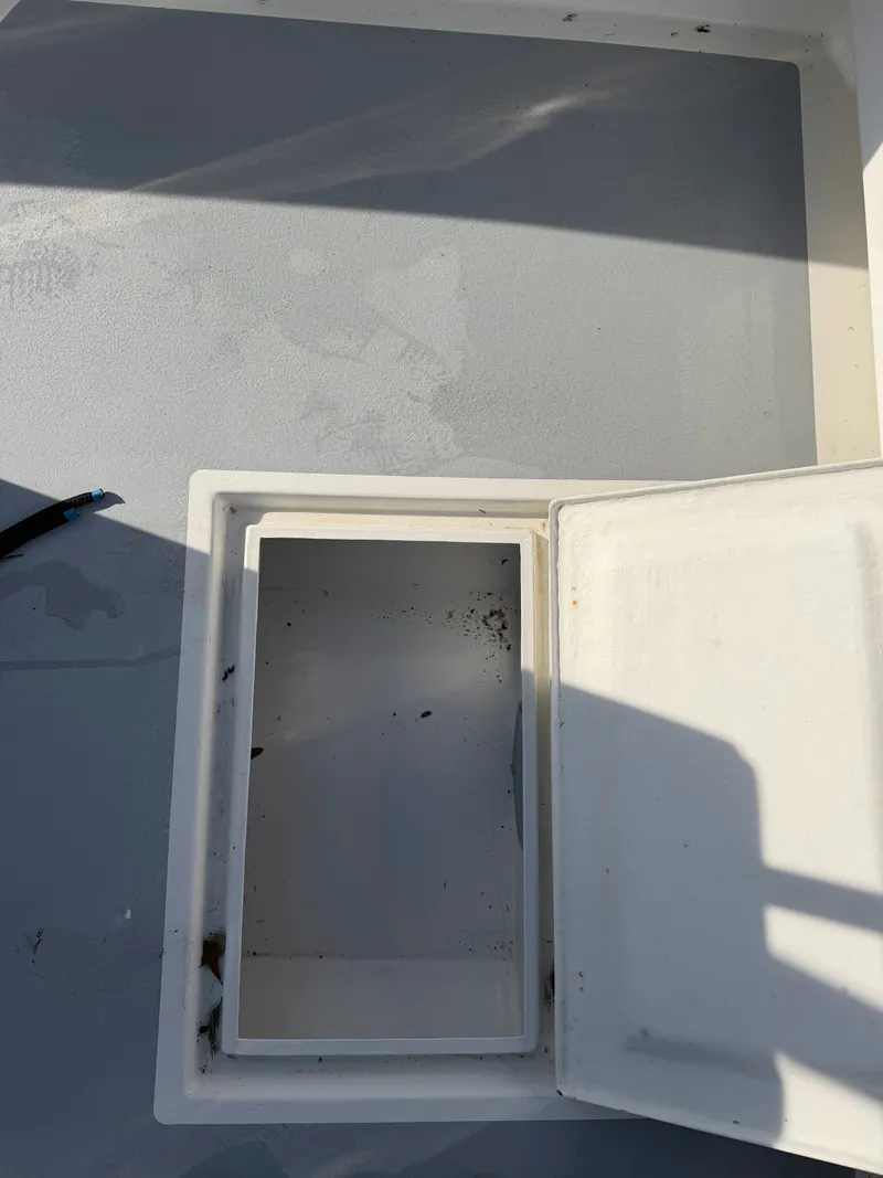 Slide: The Image of Open storage compartment on a 2022 Eastern 22 Center Console boat. - 19