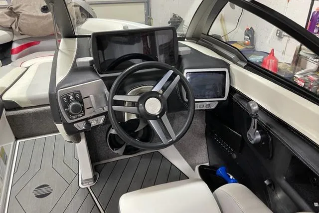 Slide: The Image of 2018 Malibu Wakesetter 23 LSV boat dashboard with steering wheel and control panels. - 3