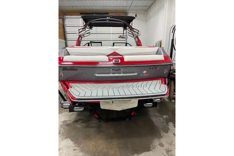 Slide: The Image of 2018 Malibu Wakesetter 23 LSV boat in a garage, rear view. - 4