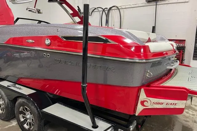 Slide: The Image of 2018 Malibu Wakesetter 23 LSV boat in red and gray on a trailer. - 5