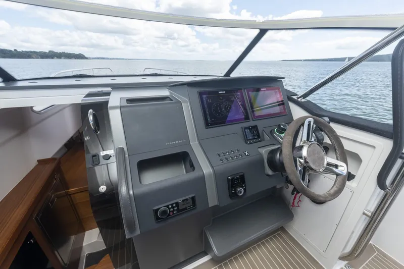 Slide: The Image of Helm of Nimbus Tender 11 yacht, 2025 model, on open water. - 10