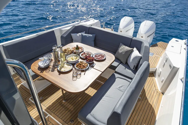 Slide: The Image of Luxurious deck of Nimbus Tender 11, 2025, with set table on the sea. - 12