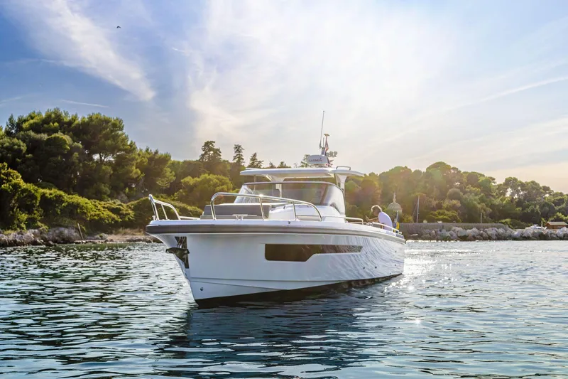 Slide: The Image of Nimbus Tender 11 boat 2025 on calm water near coastal landscape. - 4