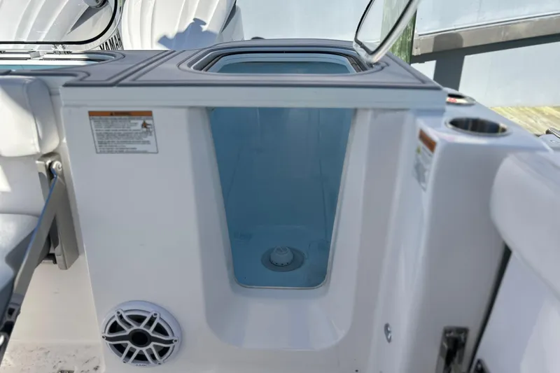 Slide: The Image of 2026 Sea Fox 288 Commander boat storage compartment with open lid and visible speaker. - 23