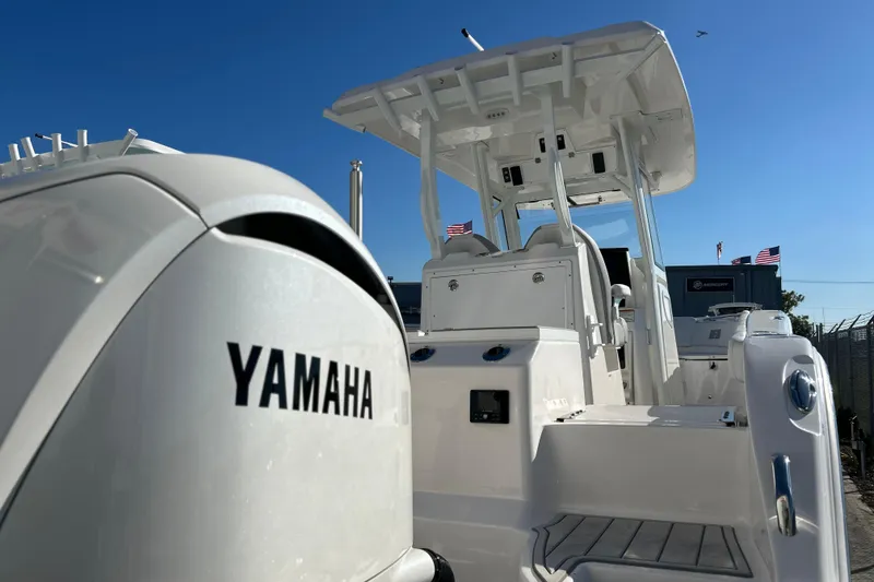 Slide: The Image of 2026 Sea Fox 288 Commander boat with Yamaha engine, docked under clear blue sky. - 40