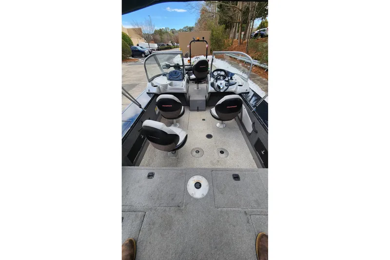 Slide: The Image of 2013 Tracker Targa V-18 WT boat interior with seating and steering console. - 2