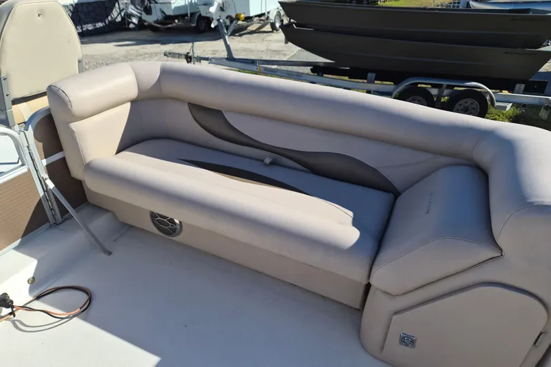 Slide: The Image of 2013 Hurricane FunDeck 226 boat interior with beige seating and storage compartment. - 10