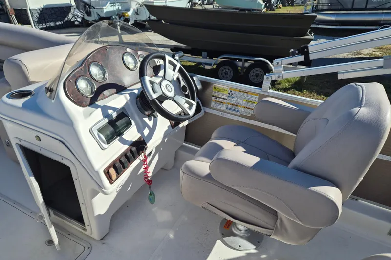 Slide: The Image of 2013 Hurricane FunDeck 226 boat cockpit with steering wheel and comfortable captain's chair. - 5