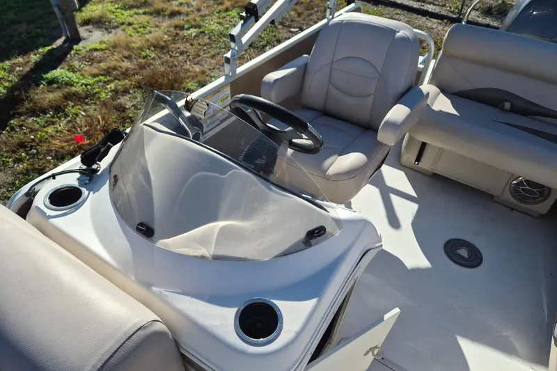 Slide: The Image of 2013 Hurricane FunDeck 226 boat interior with steering wheel and seating. - 6