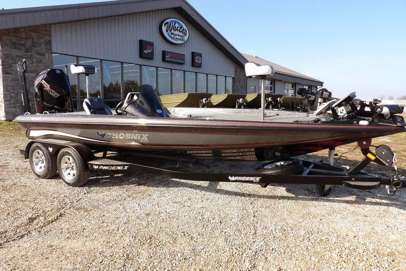 The Image of 2024 Phoenix 721 ProXP boat on trailer outside marine center. - 1